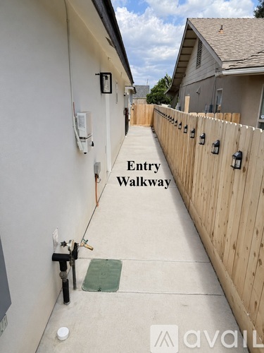 A narrow entry walkway between two houses.
