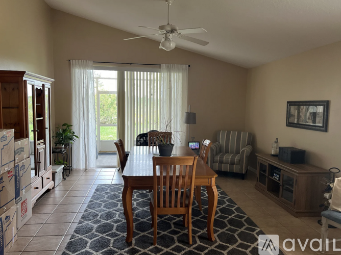 A dining room with a table and chairs.