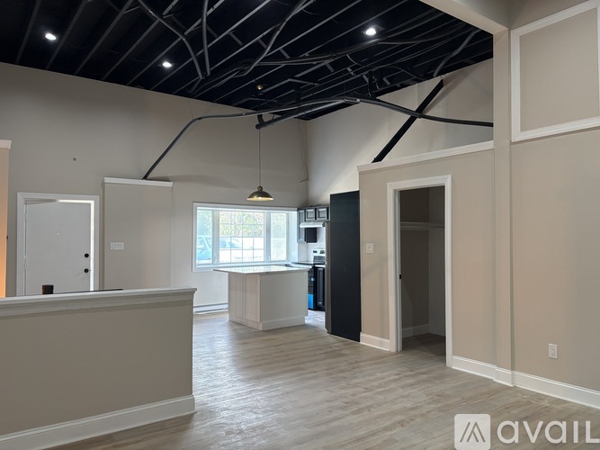A spacious interior room with a reception desk and a large window.
