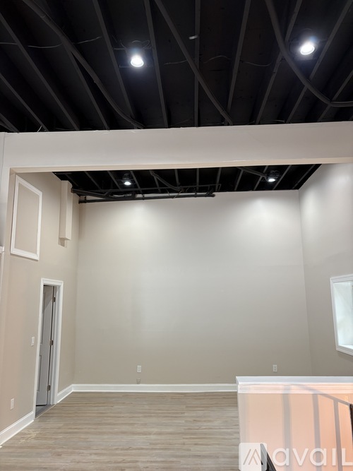 A room with a white wall and a door.