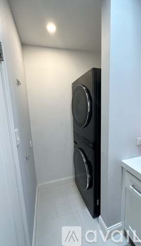 A black oven and microwave in a small kitchen.