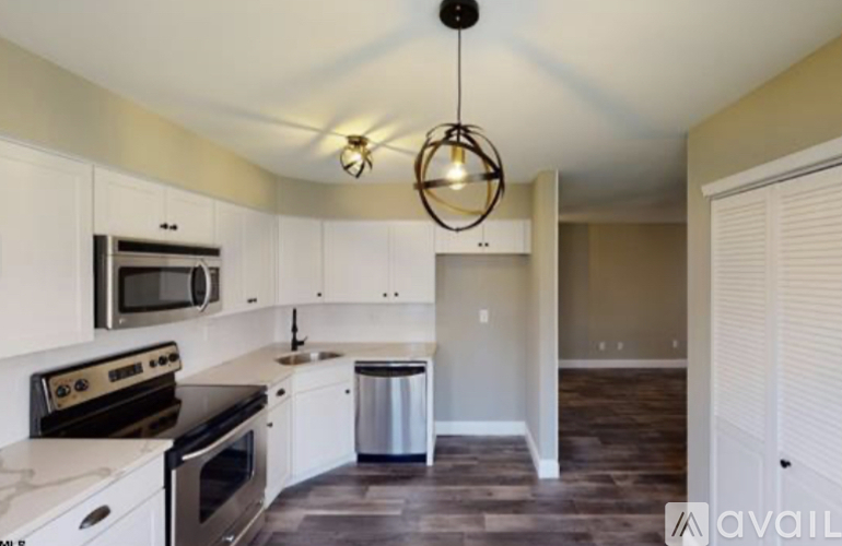 A kitchen with white cabinets and a black stove top oven.