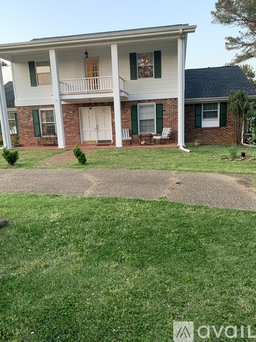 A two-story house with a white front porch.