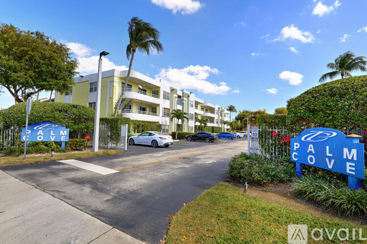 Palm Cove apartment complex with a car parked in front.