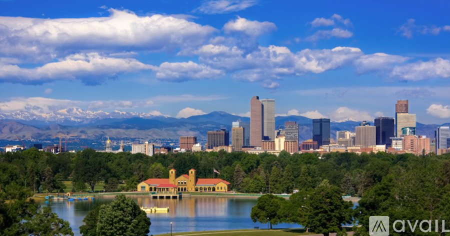A cityscape with a large body of water and a building with a red roof.