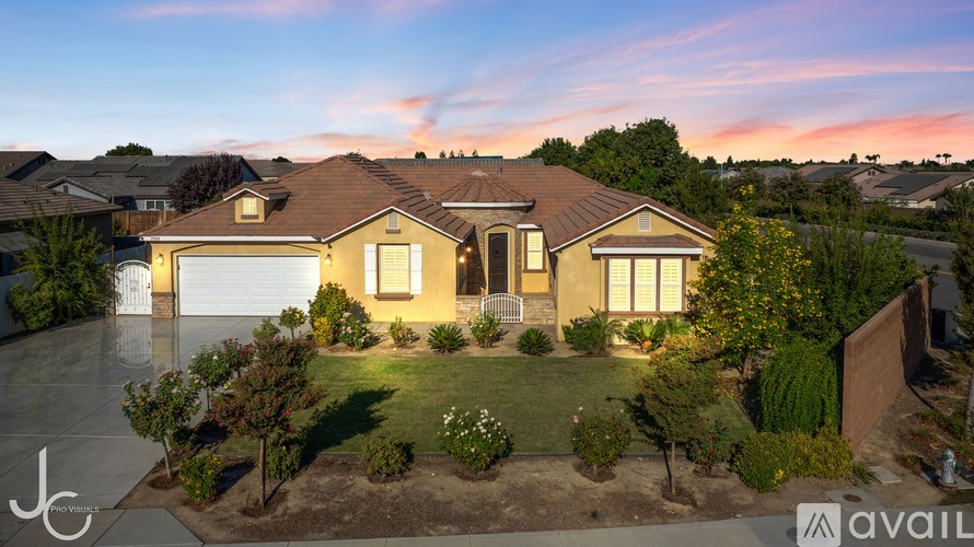 A house with a well-maintained lawn and a driveway is available for purchase.