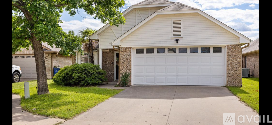 A house with a white garage door is for sale.