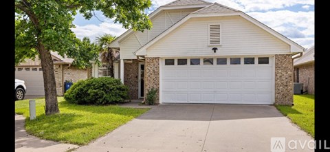 A house with a white garage door is for sale.