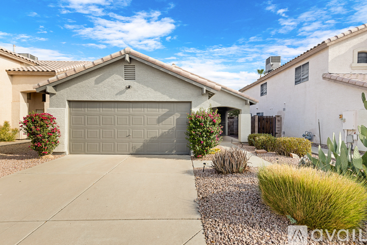A house with a garage and a driveway with a gravel area in front.