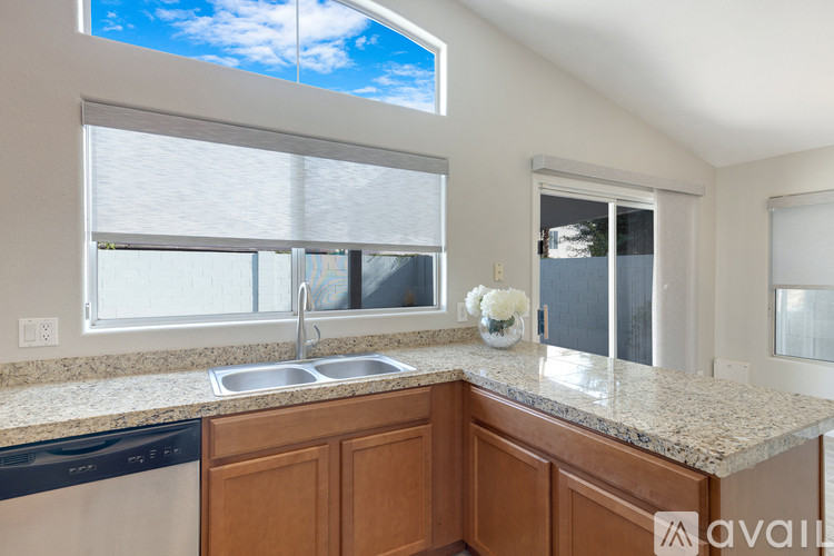 A kitchen with a sink and a window.