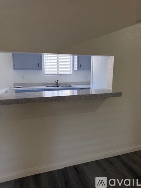 A kitchen with a granite countertop and a sink.