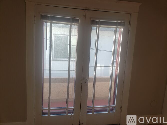 A window with a view of a building outside.