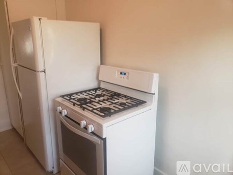 A white fridge and stove in a kitchen.