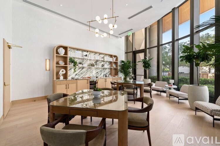 A modern dining room with a glass table and chairs.