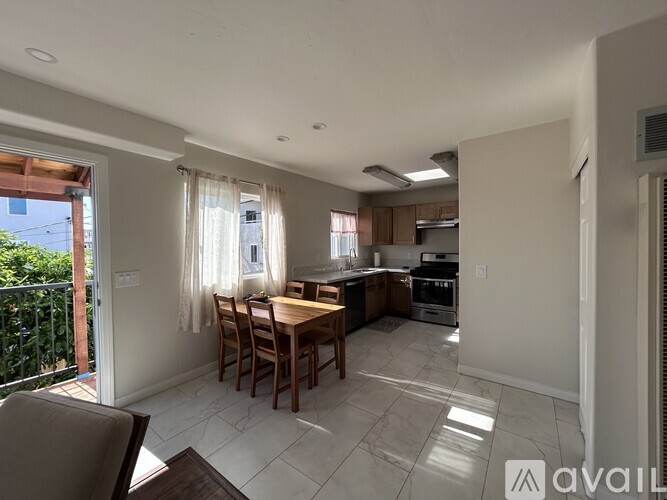 A kitchen with a table and chairs is available for rent.
