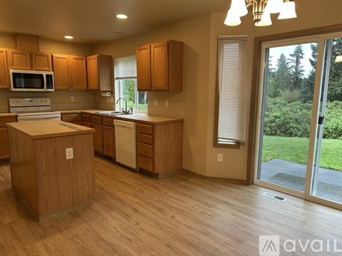 A kitchen with wooden cabinets and a white countertop.