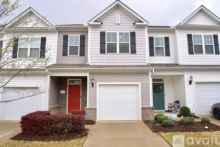 A two-story house with a red door and a green door.