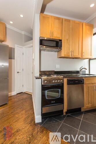 A kitchen with wooden cabinets and stainless steel appliances.