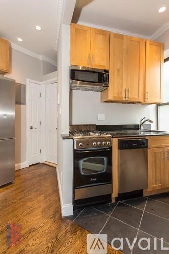 A kitchen with wooden cabinets and stainless steel appliances.