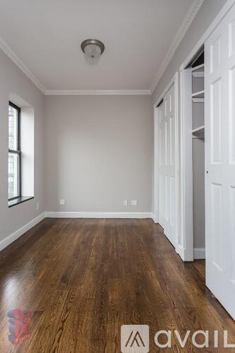 A room with wooden floors and white walls.