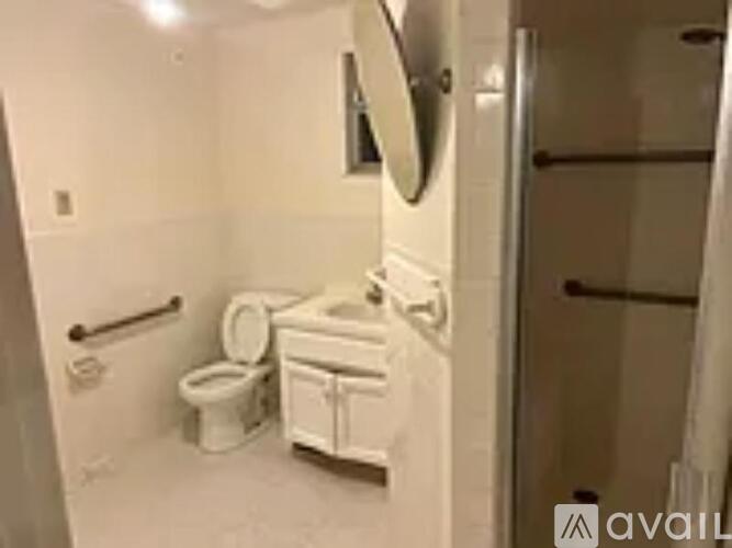 A white toilet and sink in a small bathroom.