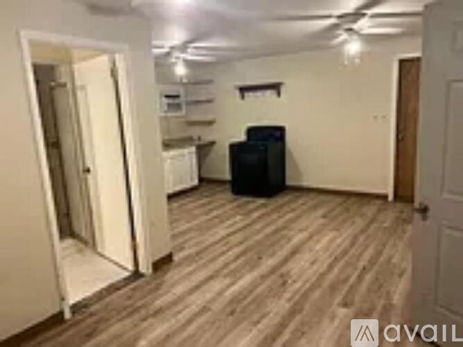 A room with wooden flooring and a black speaker in it.