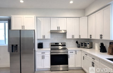 A kitchen with white cabinets and stainless steel appliances.