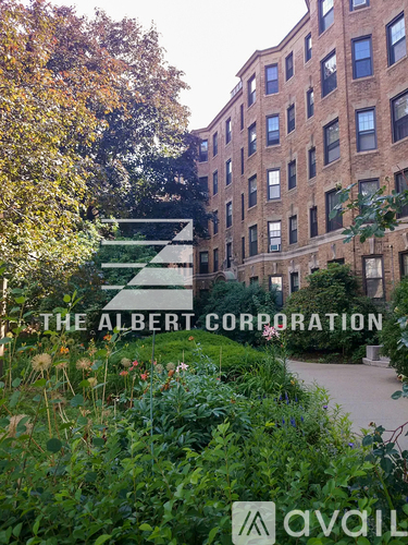 A building with a garden in front of it and the words "The Albert Corporation" written on it.
