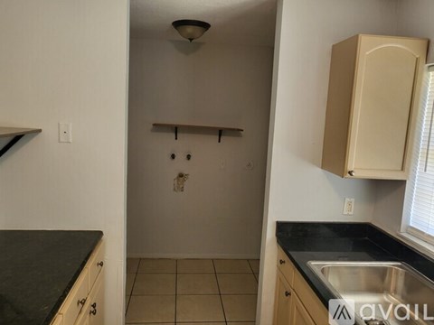 A kitchen with a sink and cabinets.