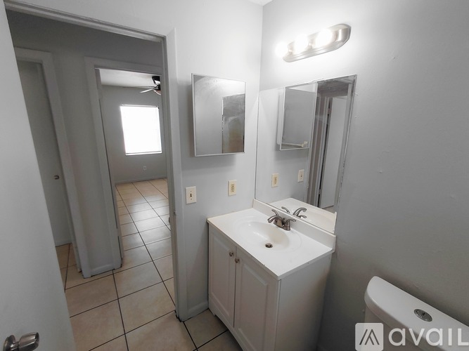 A bathroom with a sink, mirror, and toilet.