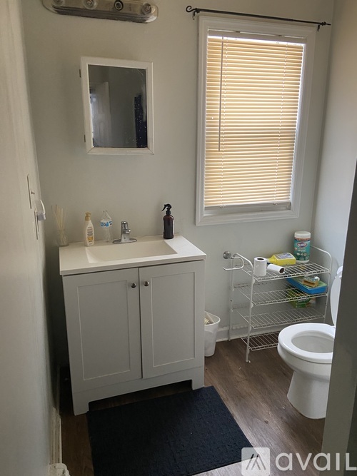 A bathroom with a white sink and toilet.