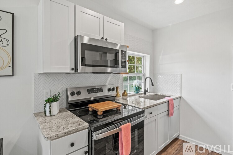 A kitchen with a stove top oven and microwave above it.