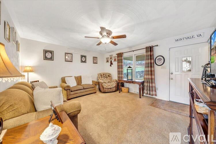 A living room with a couch, chair, and a table with a napkin on it.