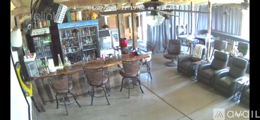 A bar area with a counter and chairs.