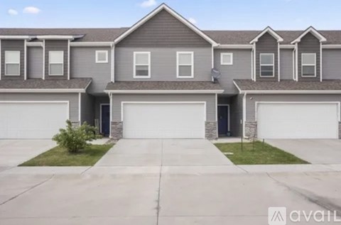 A row of houses with garages in front.