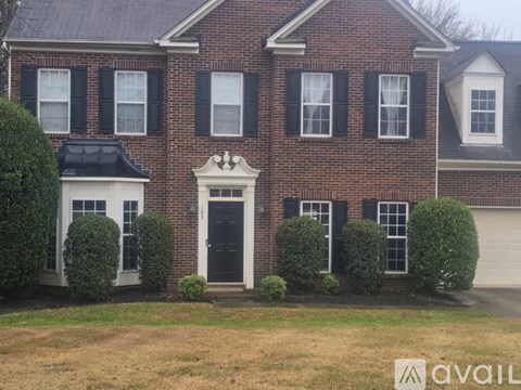 A brick house with a black door and windows.