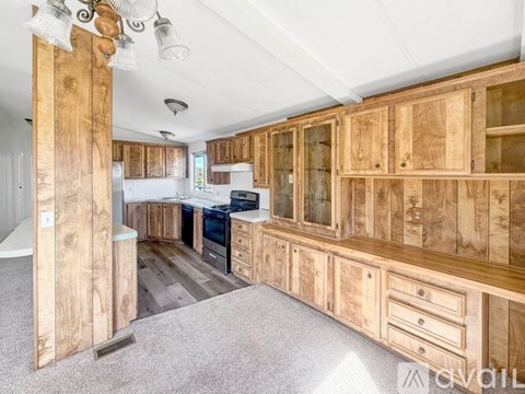 A kitchen with wooden cabinets and a white refrigerator.