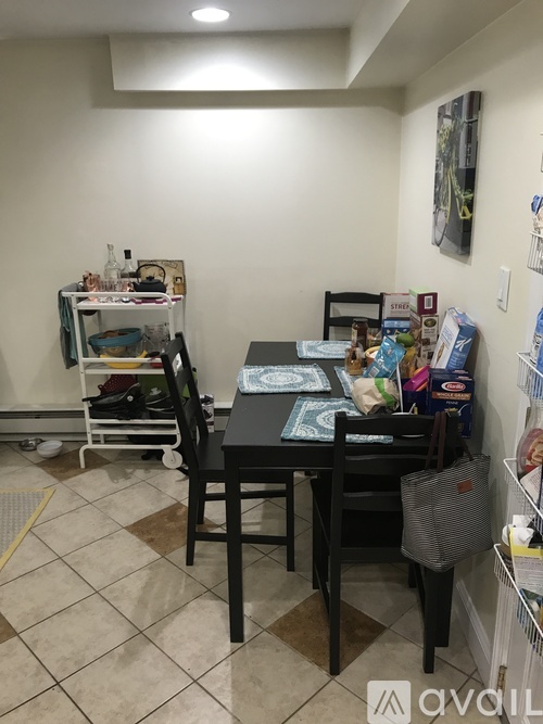 A dining room with a table and chairs.