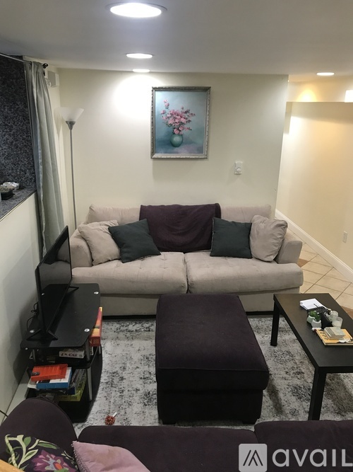 A living room with a grey couch and a coffee table.