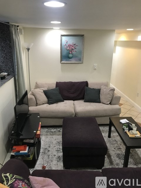 A living room with a grey couch and a coffee table.