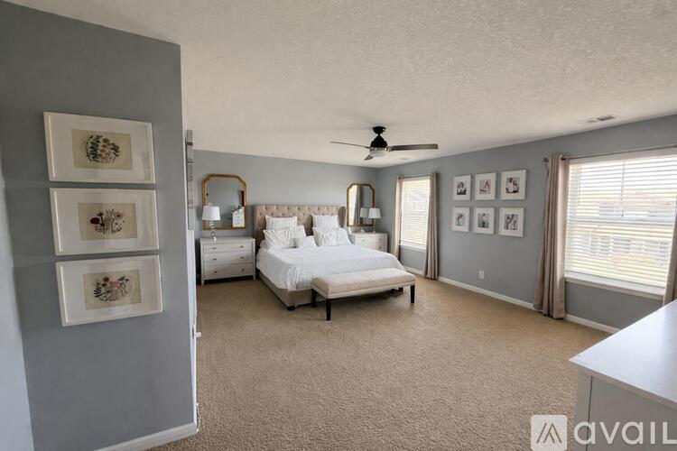 A bedroom with a bed, dresser, and mirror.