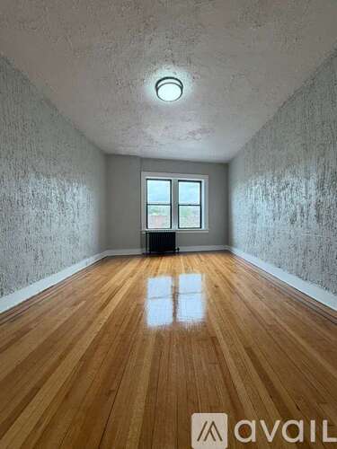 A room with wooden floors and a window.