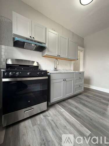 A kitchen with a stove and cabinets.
