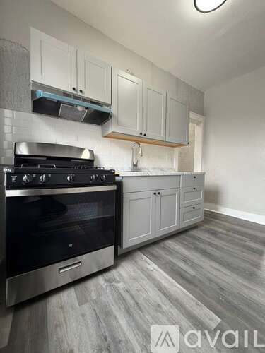 A kitchen with a stove and cabinets.