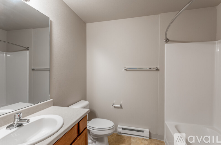 A bathroom with a toilet, sink, and bathtub.
