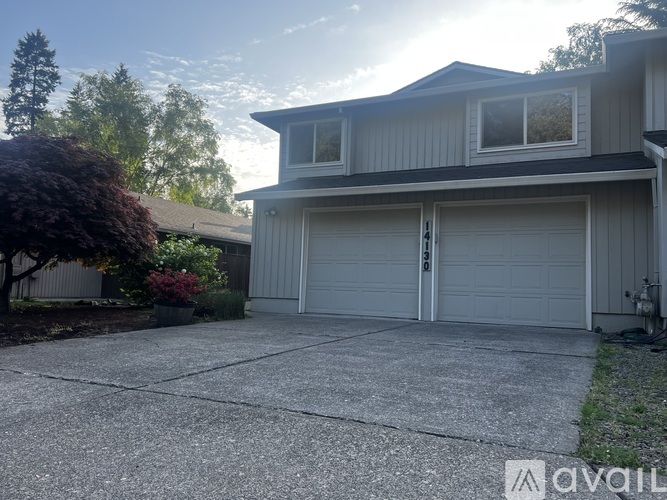 A house with a garage and a driveway.