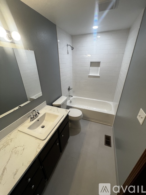 A bathroom with a sink, toilet, and bathtub.