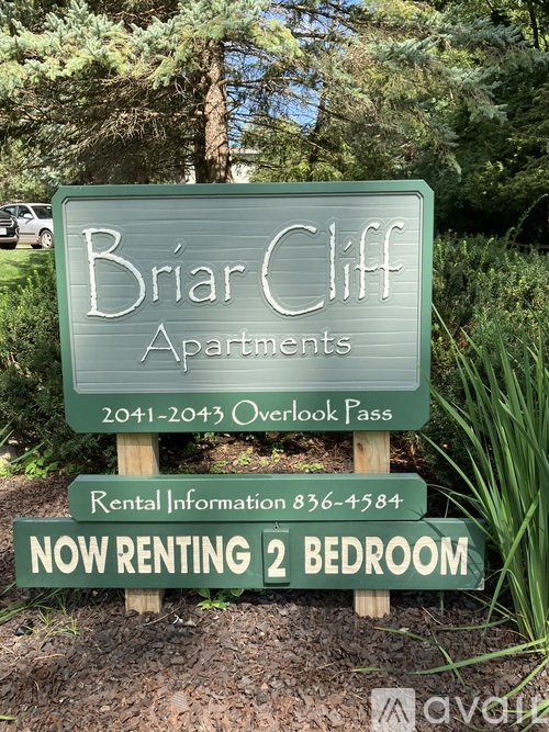 A sign for Briar Cliff Apartments with a phone number for rental information and a note that a 2 bedroom apartment is now renting.