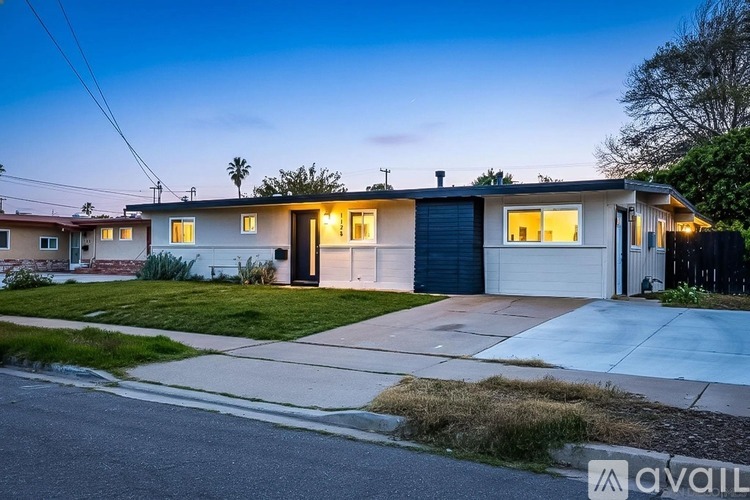 A two-story house with a garage is available for rent.