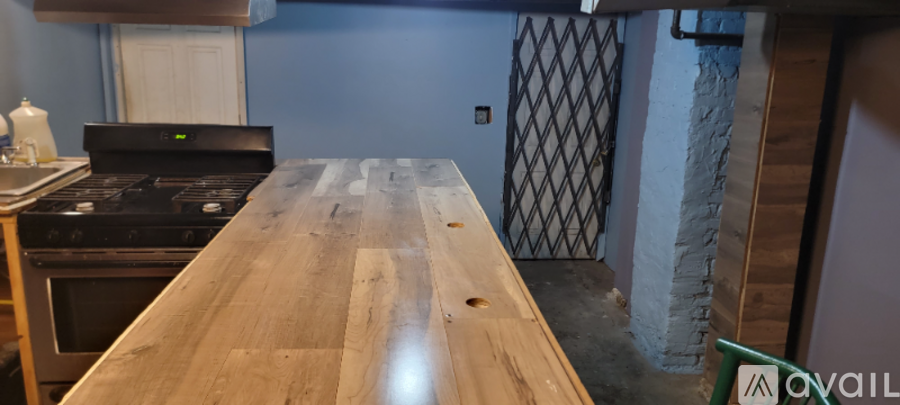 A kitchen with a wooden counter top and a black stove.